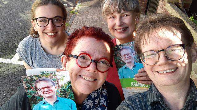 Selfie photo of four happy Green Party volunteers with leaflets.